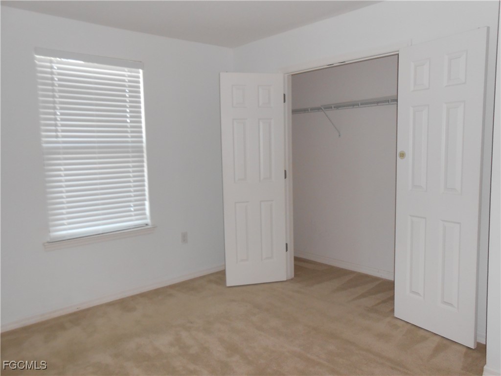 154 Shadowview Court Lehigh Acres, FL 33974 - Photo 28 of 40 a view of an empty room with a window