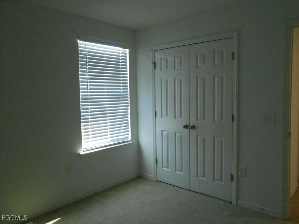 154 Shadowview Court Lehigh Acres, FL 33974 - Photo 30 of 40 a view of an empty room with a window