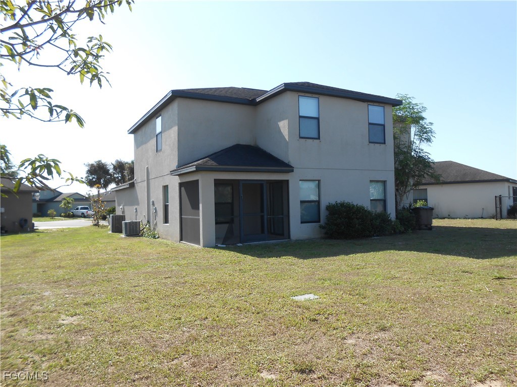 154 Shadowview Court Lehigh Acres, FL 33974 - Photo 39 of 40 a view of a house with a yard