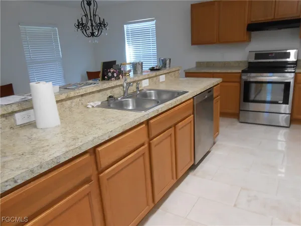 a kitchen with stainless steel appliances granite countertop a sink and a stove