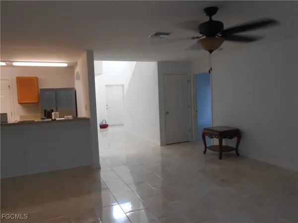 a view of a hallway and a livingroom with a furniture