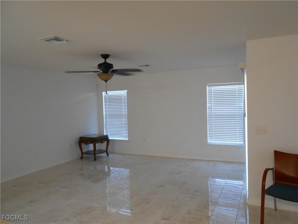 154 Shadowview Court Lehigh Acres, FL 33974 - Photo 10 of 40 a view of work space with a window and a ceiling fan