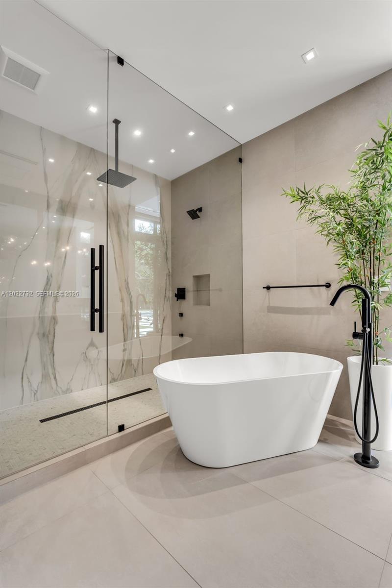 7825 Southwest 128th Street Pinecrest, FL 33156 - Photo 28 of 88 a white bath tub sitting next to a shower