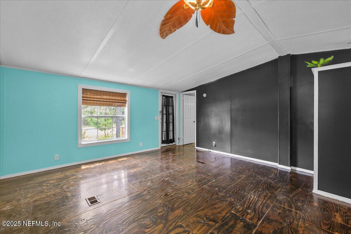 301 Kitty Avenue Interlachen, FL 32148 - Photo 11 of 23 an empty room with window and ceiling fan