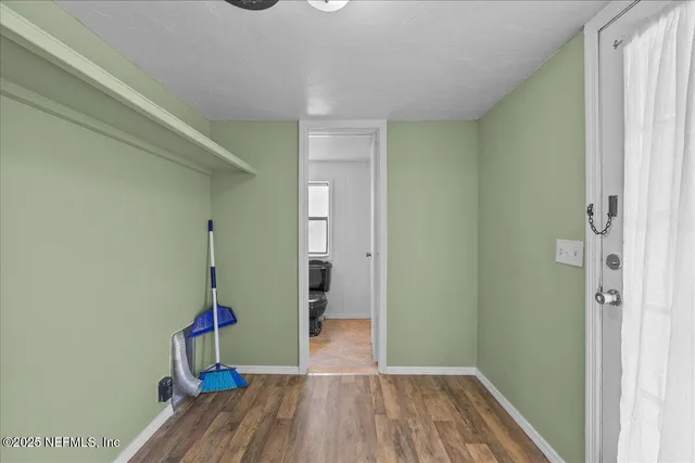 a view of hallway with wooden floor