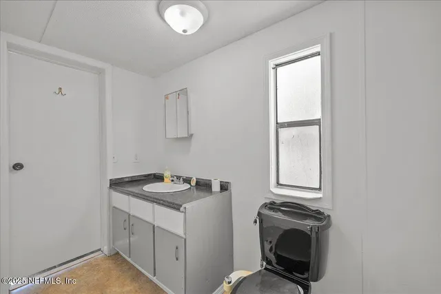 a utility room with sink dryer and washer