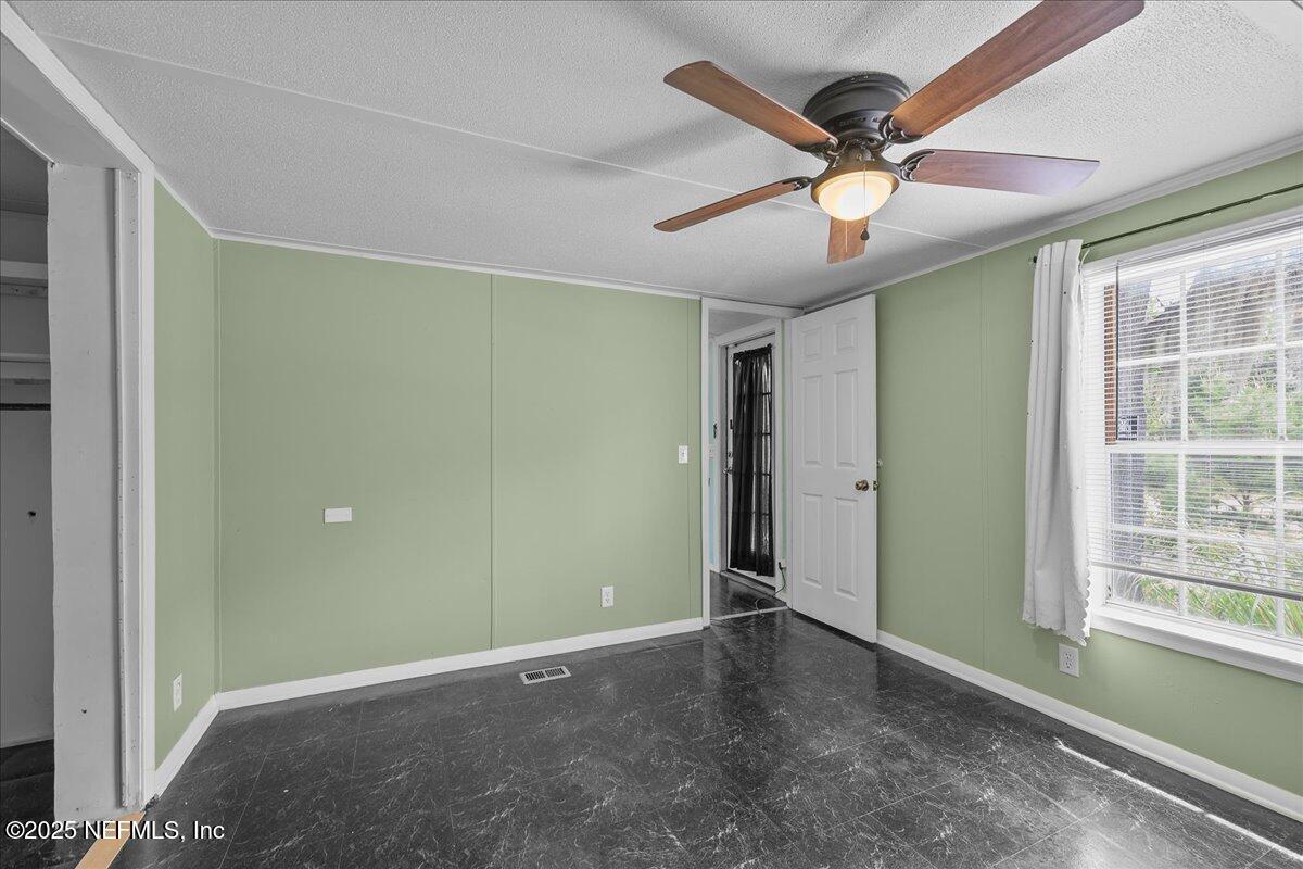 301 Kitty Avenue Interlachen, FL 32148 - Photo 17 of 23 a view of an empty room with a window