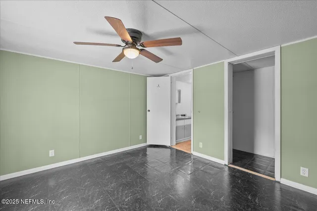 a view of a room with a ceiling fan