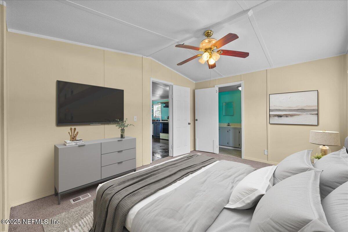 301 Kitty Avenue Interlachen, FL 32148 - Photo 20 of 23 a bedroom with a bed and a flat screen tv