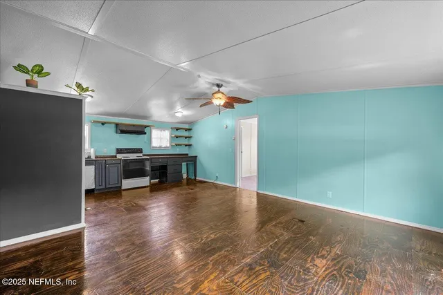 a view of a livingroom with furniture and an empty room