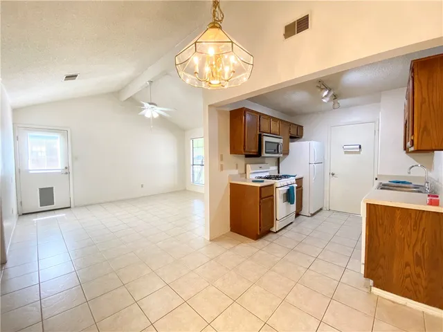 a view of a kitchen with a sink and a window
