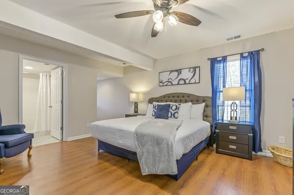 a bedroom with a bed and wooden floor