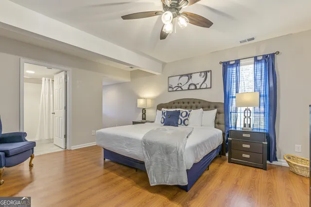 a bedroom with a bed and wooden floor