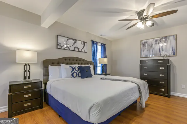 a bedroom with a bed and a night stand