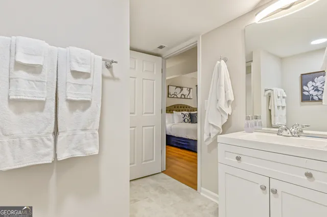 a bathroom with a sink mirror and shower