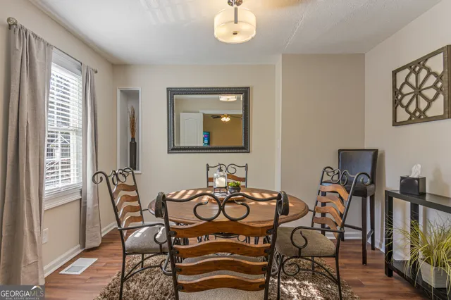 a view of a dining room with furniture window and wooden floor