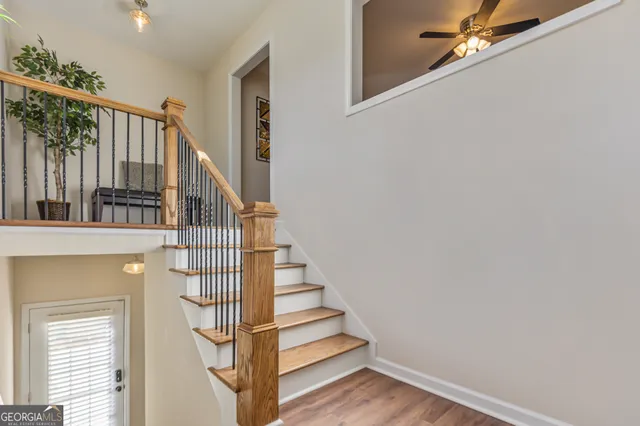 a view of entryway and hall with wooden floor