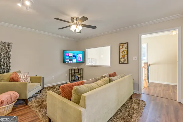 a living room with furniture and a flat screen tv