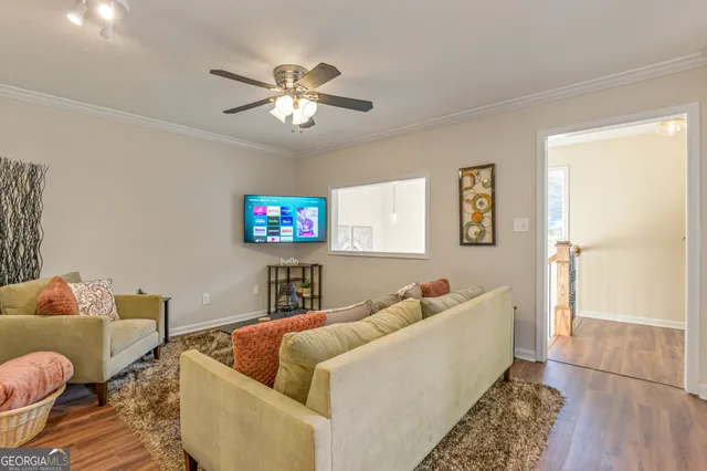 a living room with furniture and a flat screen tv