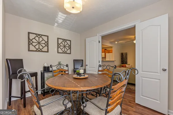 a view of a dining room with furniture and wooden floor