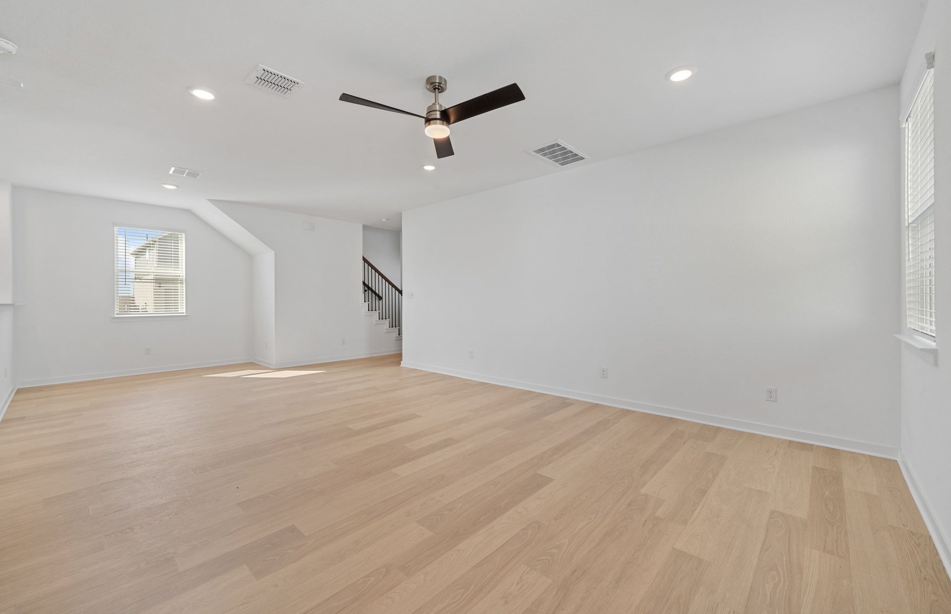 608 Rubber Tree Way Buda, TX 78610 - Photo 10 of 29 a view of empty room with wooden floor and fan