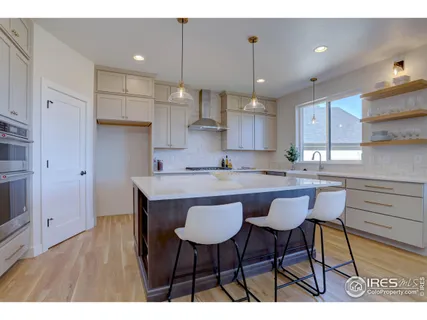 a kitchen with a dining table chairs refrigerator and cabinets