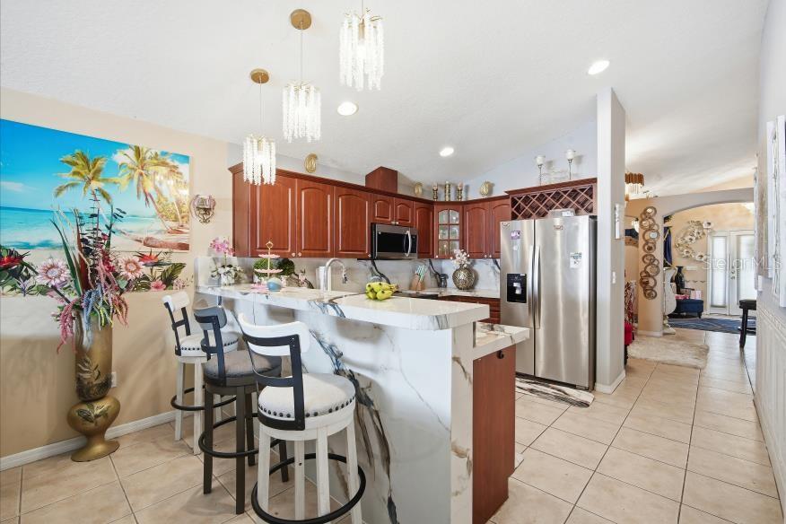 3005 West Chestnut Street Tampa, FL 33607 - Photo 11 of 27 a kitchen with a refrigerator and table chairs