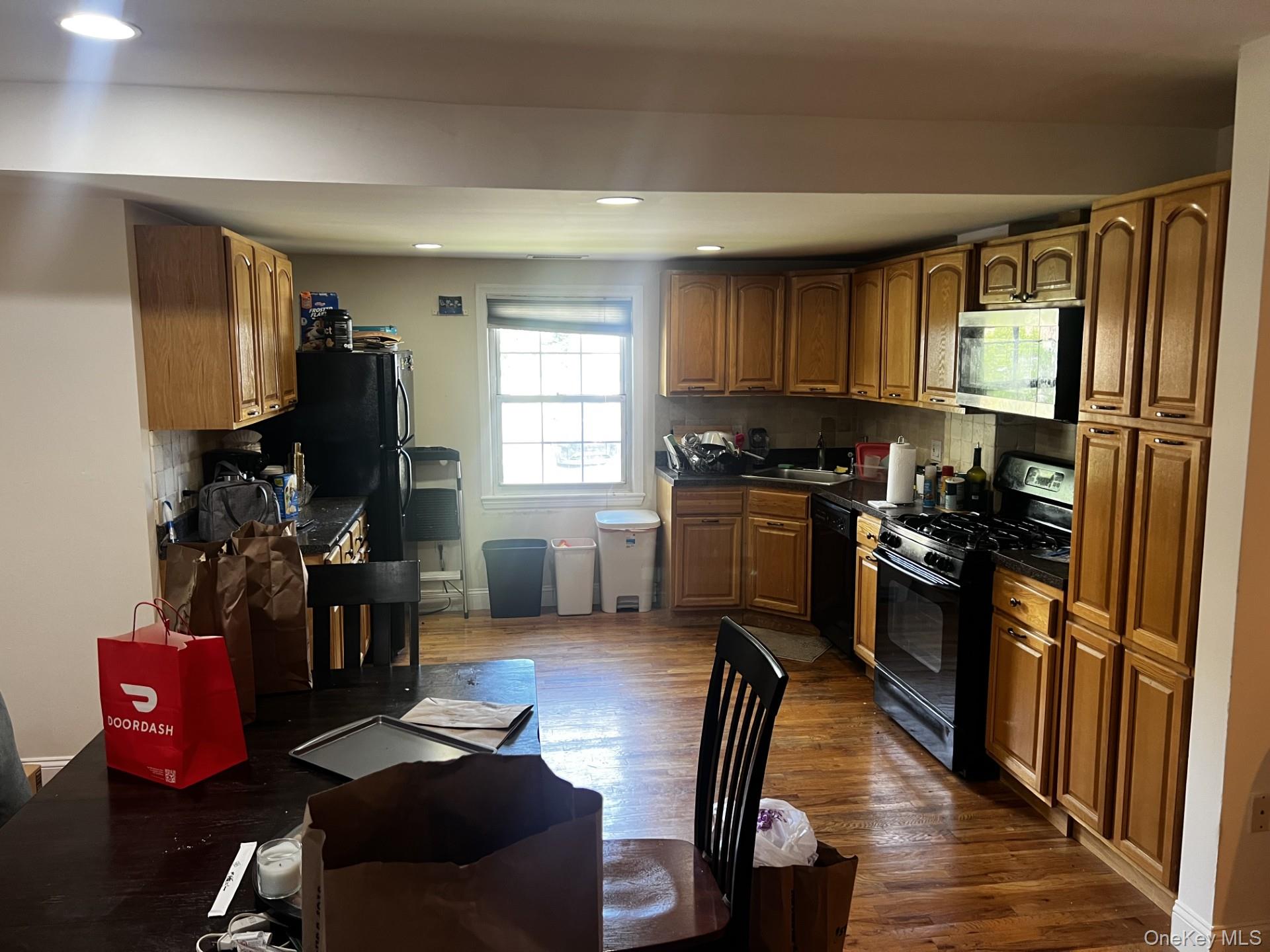 349 County Center Road, Unit TOP White Plains, NY 10603 - Photo 7 of 17 a kitchen with stainless steel appliances kitchen island granite countertop a refrigerator a stove top oven a sink and dishwasher