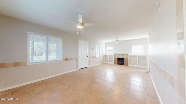 a view of a livingroom with an empty space and a fireplace