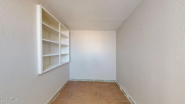 a view of an empty room with closet