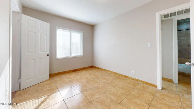 an empty room with windows and closet