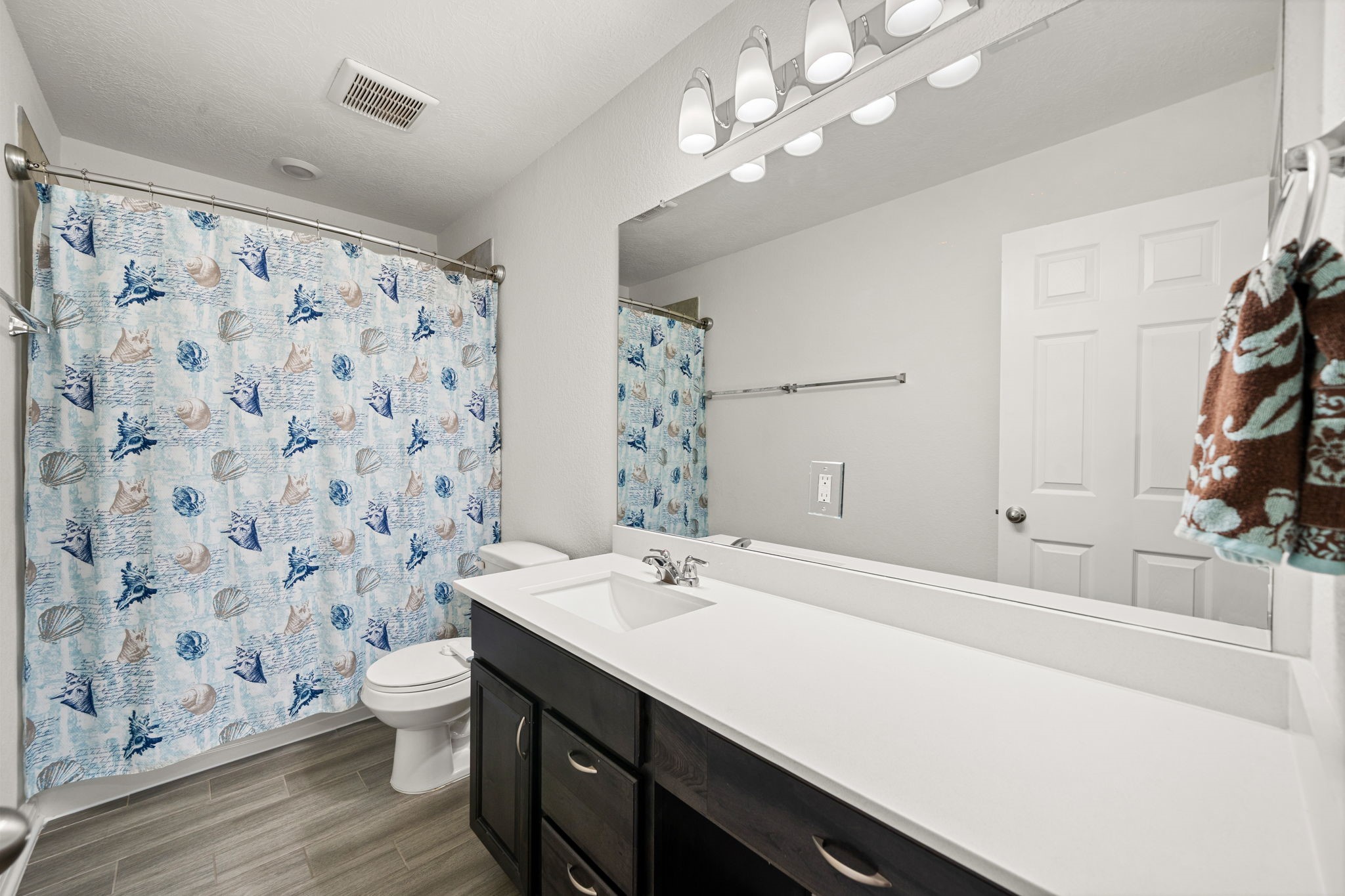 20811 Filbert Lane Katy, TX 77449 - Photo 22 of 43 a bathroom with a sink a toilet and shower curtain