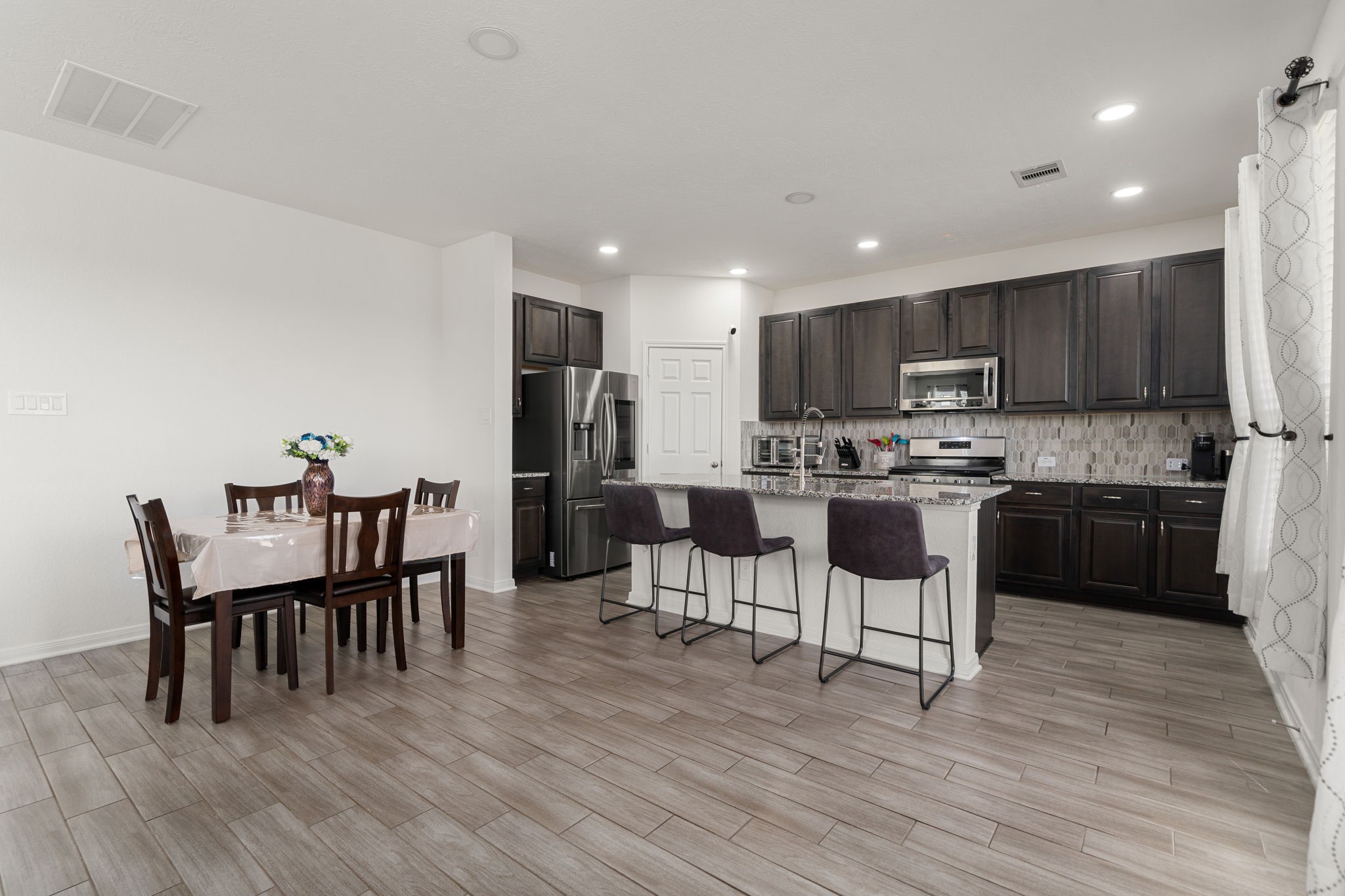 20811 Filbert Lane Katy, TX 77449 - Photo 8 of 43 a kitchen with a dining table chairs and wooden floor