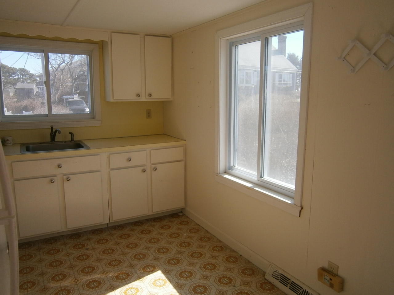 207 Captain Chase Road Dennis Port, MA 02639 - Photo 12 of 12 a kitchen with a sink window and cabinets