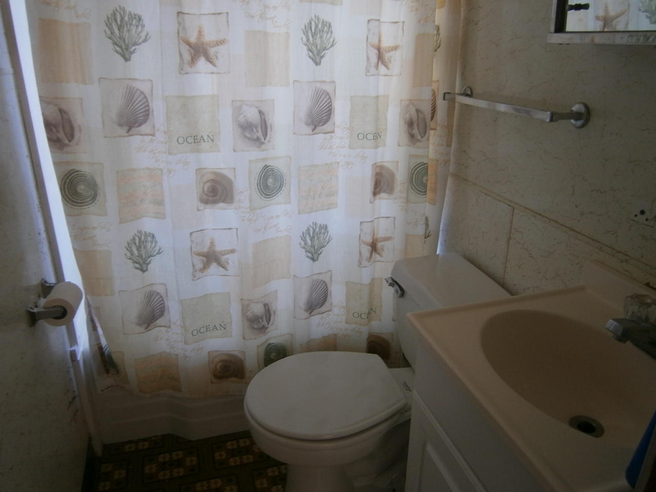 207 Captain Chase Road Dennis Port, MA 02639 - Photo 6 of 12 a white toilet sitting next to a bath tub