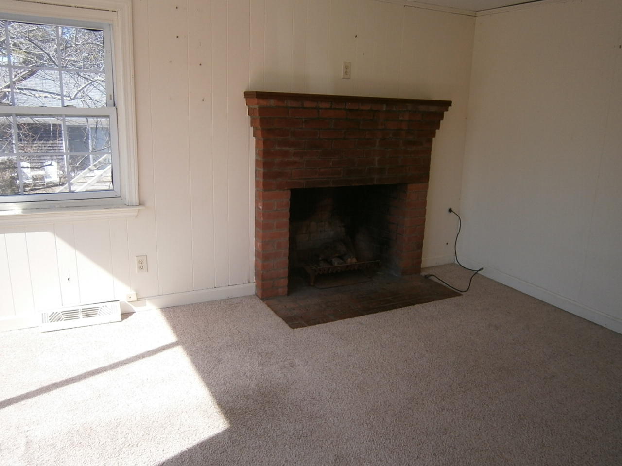 207 Captain Chase Road Dennis Port, MA 02639 - Photo 7 of 12 a room with a fireplace and a window