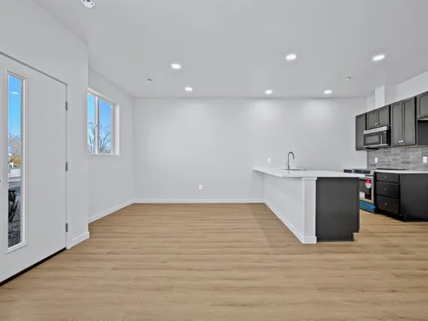 a view of kitchen with microwave and cabinets
