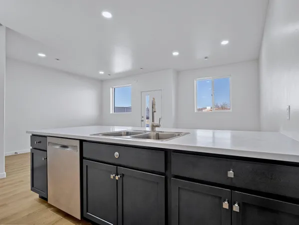 a kitchen with a sink stainless steel appliances and cabinets