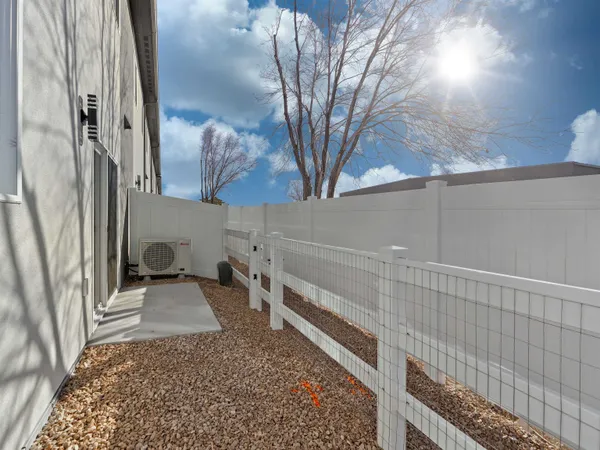 a view of a pathway of a house with a large tree