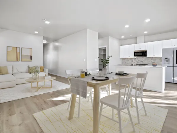 a view of kitchen with stainless steel appliances refrigerator stove dining table and chairs