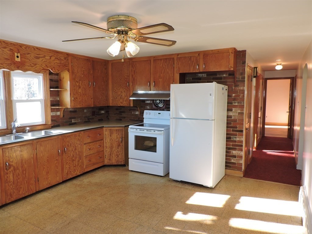 9 Park Road Webster, MA 01570 - Photo 9 of 41 a kitchen with stainless steel appliances granite countertop a refrigerator a stove a sink and a microwave