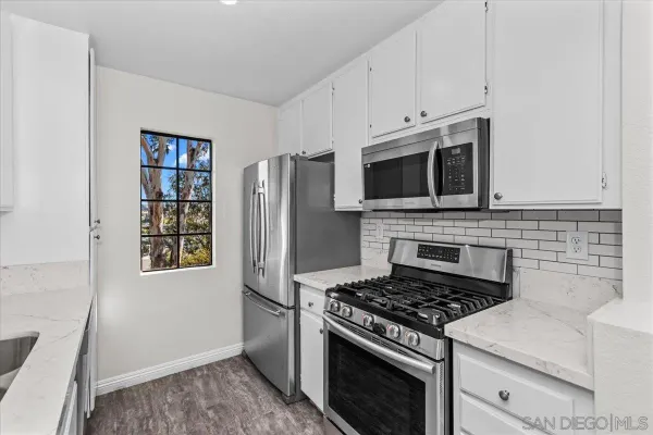a kitchen with stainless steel appliances a stove a microwave and a refrigerator