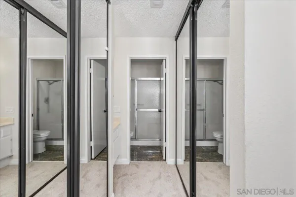 a bathroom with a glass door shower and a sink