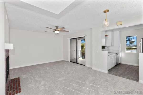 wooden floor in an empty room with a kitchen