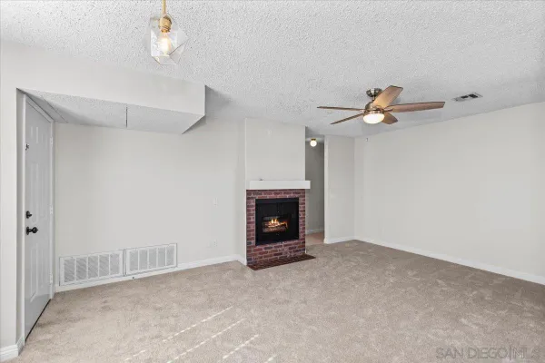a view of an empty room with a fireplace