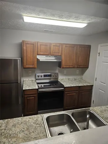 a kitchen with a sink and a refrigerator