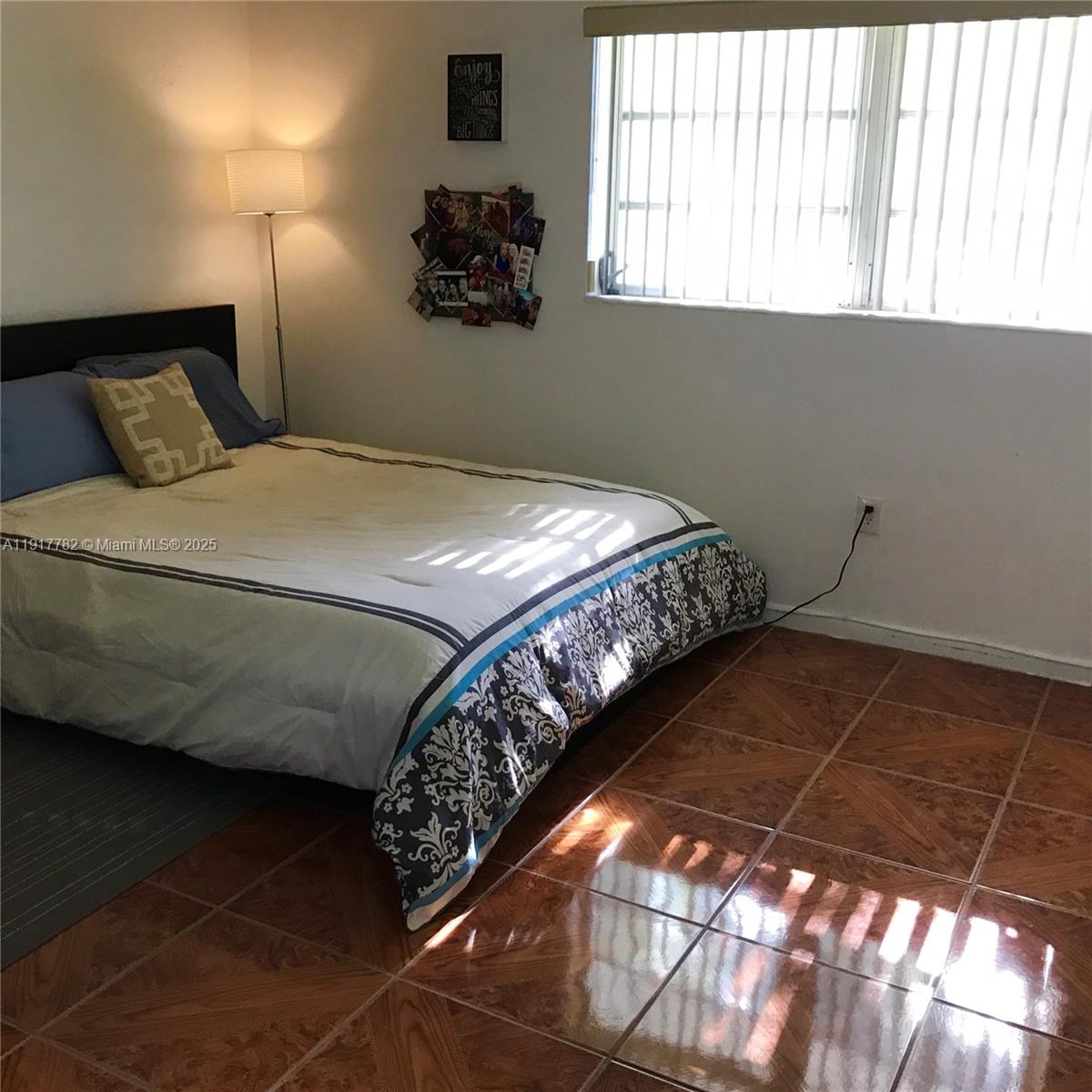 7328 Southwest 82nd Street, Unit B213 Miami, FL 33143 - Photo 11 of 22 a bedroom with a bed and a window