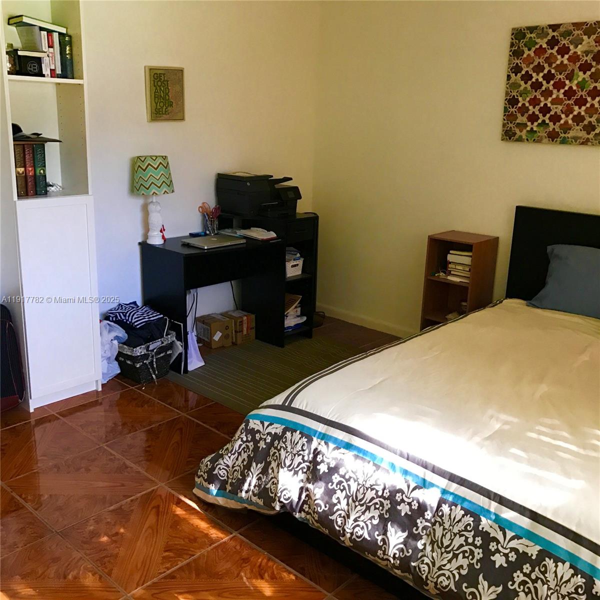 7328 Southwest 82nd Street, Unit B213 Miami, FL 33143 - Photo 12 of 22 a bedroom with a bed and a chandelier