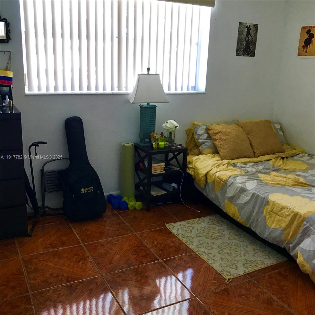 7328 Southwest 82nd Street, Unit B213 Miami, FL 33143 - Photo 13 of 22 a bedroom with a bed a dresser and a window