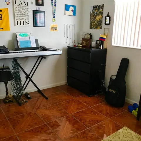 a bedroom with a bed and a desk